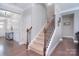 Inviting entryway with hardwood floors, staircase, and detailed trim work at 2014 Burton Point Ct, Waxhaw, NC 28173