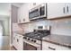 A kitchen featuring white cabinets, granite countertops, stainless steel appliances, and a subway tile backsplash at 2014 Burton Point Ct, Waxhaw, NC 28173