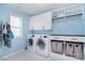 Bright laundry room with a washer, dryer, cabinetry and countertops at 2014 Burton Point Ct, Waxhaw, NC 28173