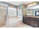 Beautiful main bathroom with a tile shower, soaking tub, double vanity and bright natural light at 2014 Burton Point Ct, Waxhaw, NC 28173