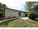 The rear exterior of the home features a well-maintained yard with a small patio area and mature shrubs at 202 Hickory St, Locust, NC 28097