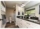 Bright bathroom with double vanity, granite counters, and a tiled glass shower at 202 Hickory St, Locust, NC 28097