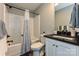 Cozy bathroom with tub and shower, and a vanity with black countertop at 202 Hickory St, Locust, NC 28097