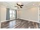 This bedroom has a decorative ceiling with recessed lights, a ceiling fan and large window at 202 Hickory St, Locust, NC 28097