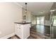 Bright dining area with sliding glass doors and access to the kitchen island with a black countertop at 202 Hickory St, Locust, NC 28097