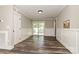 Dining room boasts natural light with wainscoting and a sliding glass door that leads to the outdoors at 202 Hickory St, Locust, NC 28097