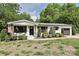 Charming single-story home with a landscaped yard, inviting front porch, and attached garage at 202 Hickory St, Locust, NC 28097