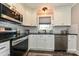 Modern kitchen features stainless steel appliances, subway tile backsplash, and dark countertops at 202 Hickory St, Locust, NC 28097