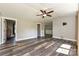 Spacious living room featuring wood floors, a ceiling fan, and ample natural light at 202 Hickory St, Locust, NC 28097