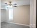 Neutral bedroom with a ceiling fan, closet and window with white trim at 206 N Kayla Dr, Salisbury, NC 28146