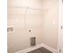 Simple laundry room with gray vinyl flooring, white walls and white shelving at 206 N Kayla Dr, Salisbury, NC 28146