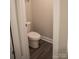 A well-lit, standard white toilet in a modern bathroom with neutral walls and wood-look flooring at 206 N Kayla Dr, Salisbury, NC 28146