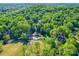 Sweeping aerial view of the community featuring lush greenery, a pond, and golf course at 209 Tinkham Trl, Cramerton, NC 28032