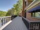 Side view of a back deck with a brick exterior at 209 Tinkham Trl, Cramerton, NC 28032