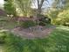 Backyard with grass, flowers, and a view of the house at 209 Tinkham Trl, Cramerton, NC 28032