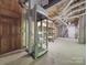 Basement with elevator, unfinished ceiling, concrete floor, and door at 209 Tinkham Trl, Cramerton, NC 28032