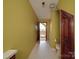 Bathroom with white tiled floors, a toilet, and a view to the staircase at 209 Tinkham Trl, Cramerton, NC 28032