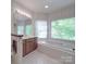 Relaxing bathroom featuring a large soaking tub, separate shower, and dual sink vanity at 209 Tinkham Trl, Cramerton, NC 28032