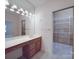 Light and bright bathroom features double sink vanity and walk in closet at 209 Tinkham Trl, Cramerton, NC 28032