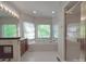 Relaxing bathroom featuring a large soaking tub, separate shower, and dual sink vanity at 209 Tinkham Trl, Cramerton, NC 28032