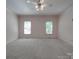 This bedroom offers great natural light from the two bright windows at 209 Tinkham Trl, Cramerton, NC 28032