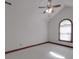 Cozy bedroom features a ceiling fan and a unique arched window at 209 Tinkham Trl, Cramerton, NC 28032