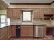 Charming kitchen featuring custom cabinets, granite countertops, and stainless steel dishwasher at 209 Tinkham Trl, Cramerton, NC 28032