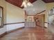 Spacious living room featuring hardwood floors, an open layout, and access to the kitchen at 209 Tinkham Trl, Cramerton, NC 28032