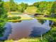 Scenic pond reflecting a blue sky and adjacent to a well-manicured golf course at 209 Tinkham Trl, Cramerton, NC 28032