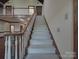 Grand staircase leads to the upper level with wooden railing and carpeted steps at 209 Tinkham Trl, Cramerton, NC 28032