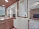 Wet bar area with wood cabinets, sink, microwave, and serving shelves at 209 Tinkham Trl, Cramerton, NC 28032