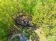 Aerial view of the home displays landscaping, privacy trees, and an outbuilding at 211 W Tennessee Ave, Bessemer City, NC 28016