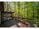 Back porch deck with a bench and a screened-in area, offering a tranquil and inviting outdoor space at 211 W Tennessee Ave, Bessemer City, NC 28016