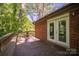 Back porch deck with a bench and doors, creating a serene and inviting outdoor space at 211 W Tennessee Ave, Bessemer City, NC 28016