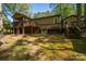 This backyard features a deck with stairs, an HVAC, and a wooded lot at 211 W Tennessee Ave, Bessemer City, NC 28016