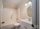 Clean bathroom with a shower-tub combo, white sink and vanity, and updated fixtures at 211 W Tennessee Ave, Bessemer City, NC 28016
