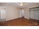 Large bedroom with ceiling fan, hardwood floors, natural light, closet and access to the bathroom at 211 W Tennessee Ave, Bessemer City, NC 28016