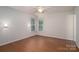 Spacious bedroom with ample natural light, ceiling fan, and hardwood floors, offering comfort and style at 211 W Tennessee Ave, Bessemer City, NC 28016
