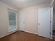 Well-lit bedroom with hardwood floors, closet and neutral paint, creating a serene and inviting atmosphere at 211 W Tennessee Ave, Bessemer City, NC 28016