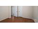 Bedroom with hardwood floors, electrical outlets, neutral paint, and closet space, providing versatile options at 211 W Tennessee Ave, Bessemer City, NC 28016
