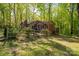 Charming brick home nestled among lush trees and a pretty front yard with a wood fence at 211 W Tennessee Ave, Bessemer City, NC 28016