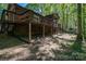 Exterior of the brick home shows the deck, a screened porch, and an outbuilding at 211 W Tennessee Ave, Bessemer City, NC 28016