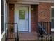 Close-up of the front entrance showcasing a decorative glass door, brick surround, and a 'Welcome' mat at 211 W Tennessee Ave, Bessemer City, NC 28016