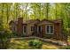 Charming home with brick and siding, accented by a brick chimney, well-tended garden, and lush surroundings at 211 W Tennessee Ave, Bessemer City, NC 28016