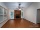The cozy living room features a brick fireplace and multiple windows for ample natural light at 211 W Tennessee Ave, Bessemer City, NC 28016