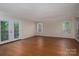 Large living room featuring wood floors, a glass paned door and lots of natural light at 211 W Tennessee Ave, Bessemer City, NC 28016