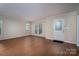 Bright living room with a large window, a glass paned front door and neutral paint at 211 W Tennessee Ave, Bessemer City, NC 28016