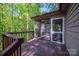 View of screened porch shows wooded views and entrance at 211 W Tennessee Ave, Bessemer City, NC 28016