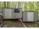 This backyard has two detached sheds with doors and one window at 211 W Tennessee Ave, Bessemer City, NC 28016