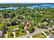 Stunning aerial view of a lakeside property with mature trees, offering privacy and natural beauty at 21907 Torrence Chapel Rd, Cornelius, NC 28031